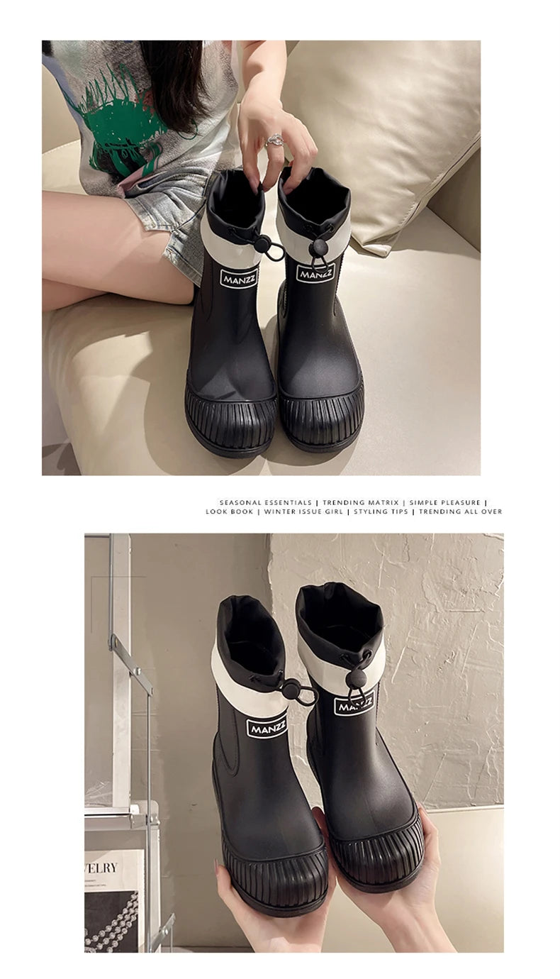 A pair of black women's waterproof mid-calf rain boots with white accents and a non-slip sole.