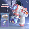 A pink and white automatic bubble machine gun is shown spraying bubbles against a dark background.