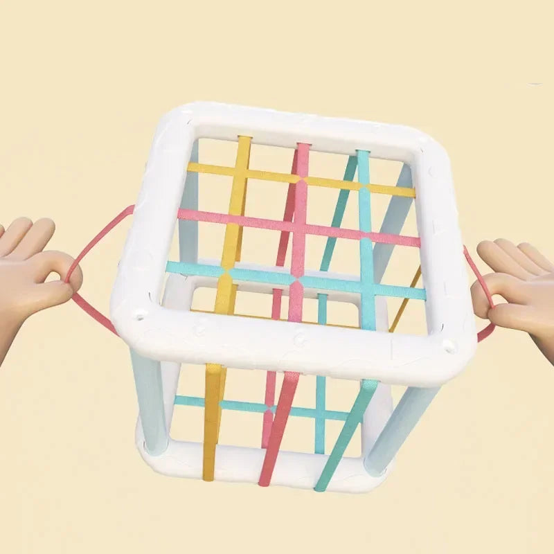 A set of colorful sensory sorting blocks with a white frame being held by hands.