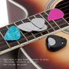 A black guitar pick holder with six colored picks resting on a wooden guitar fretboard.