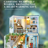 A detailed wooden miniature dollhouse kit with interior and exterior scenes, featuring decorative elements and lighting.