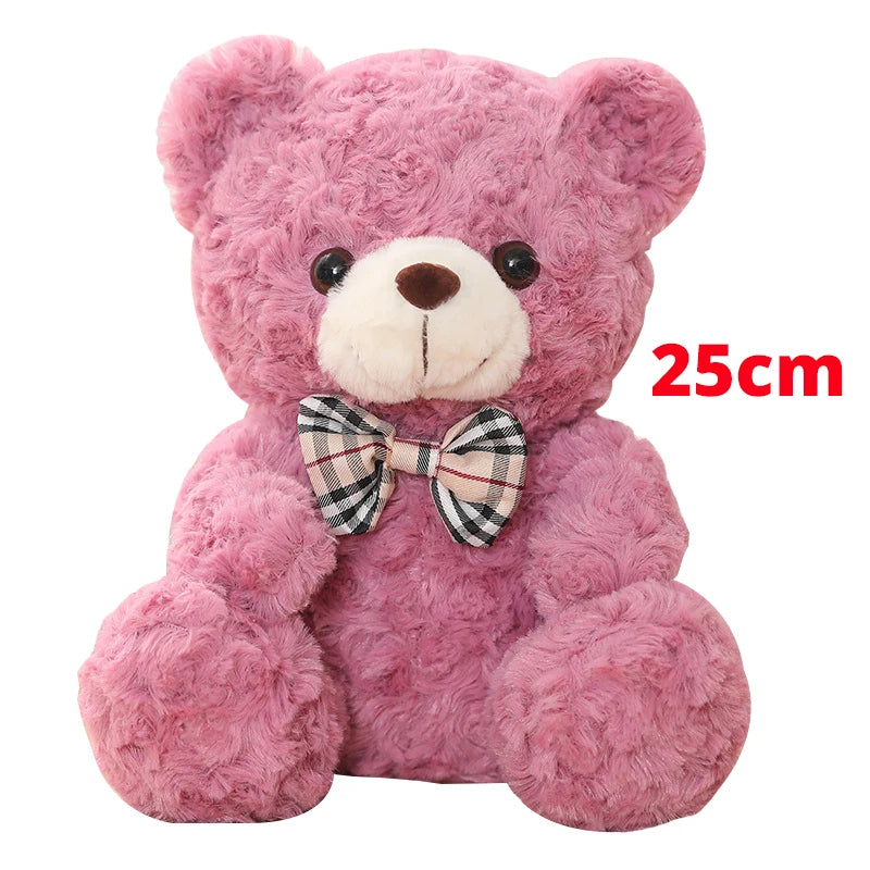A pink fluffy teddy bear plush pillow with a checkered bow