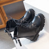 A pair of black girls' ankle boots with a double-zip closure and an anti-skid rubber sole resting on a white surface.