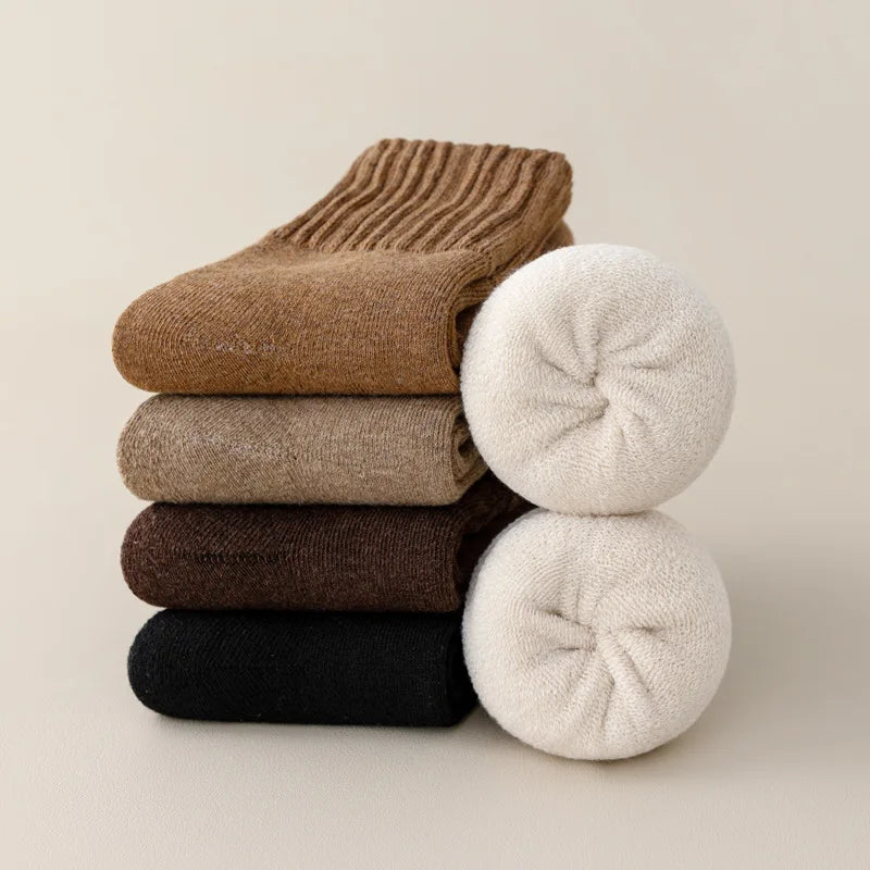 A stack of women's fleece-lined slouch socks in various shades of brown, beige, and black.