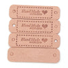 A set of four light pink leather-style handmade with love tags for crafts and sewing.