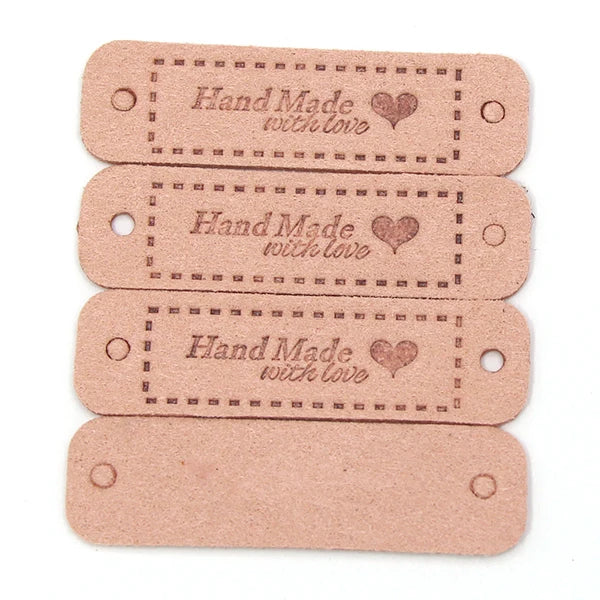 A set of four light pink leather-style handmade with love tags for crafts and sewing.