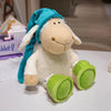 A soft white plush toy resembling a sheep with blue ears and green feet.