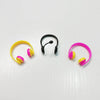 A set of mini rubber duck accessories including a yellow ring, a black hoop, and pink rings with yellow accents.