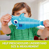 A child is holding a blue plastic shark toy for educational purposes.