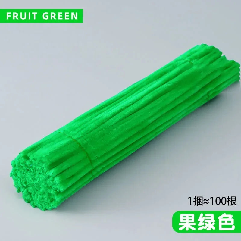 A bright green chenille stem craft product shown in a diagonal view.