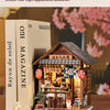 A detailed wooden miniature Japanese izakaya house kit with interior display and lighting elements.