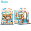A detailed 3D wooden book nook kit featuring a bakery display with LED lighting and various food items.