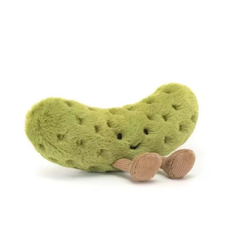 A soft, green plush pickle toy with a smiling face.