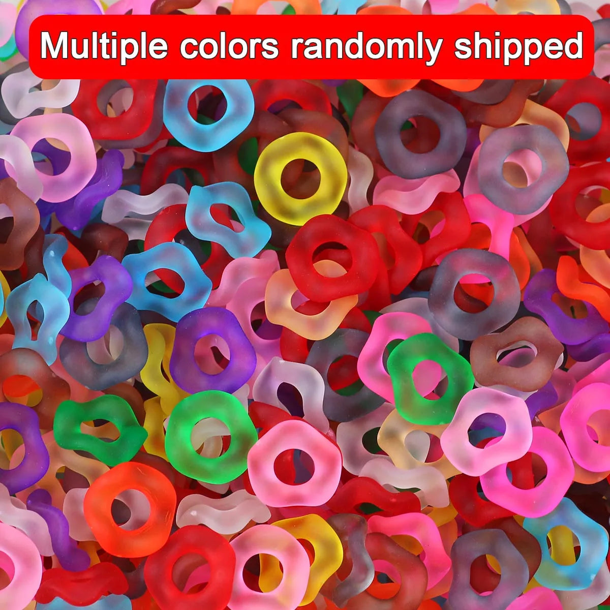 A pile of multiple colors of wave-patterned acrylic beads for jewelry making.