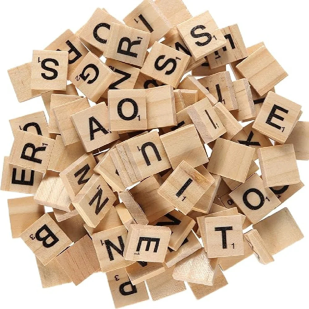 A pile of wooden alphabet letter tiles in various sizes and orientations.