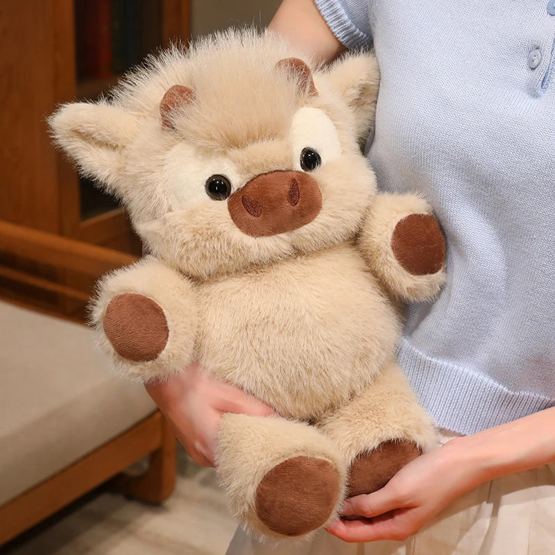 A light beige plush toy resembling a West Highland calf or running cow doll being held by a person.