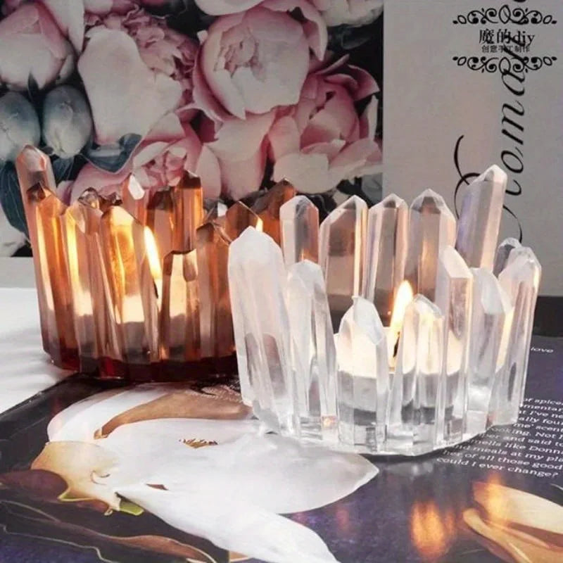 Clear silicone candle molds arranged with glowing candles on a dark surface.