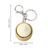 A small, round, beige steamed bun fidget toy attached to a silver keychain ring.