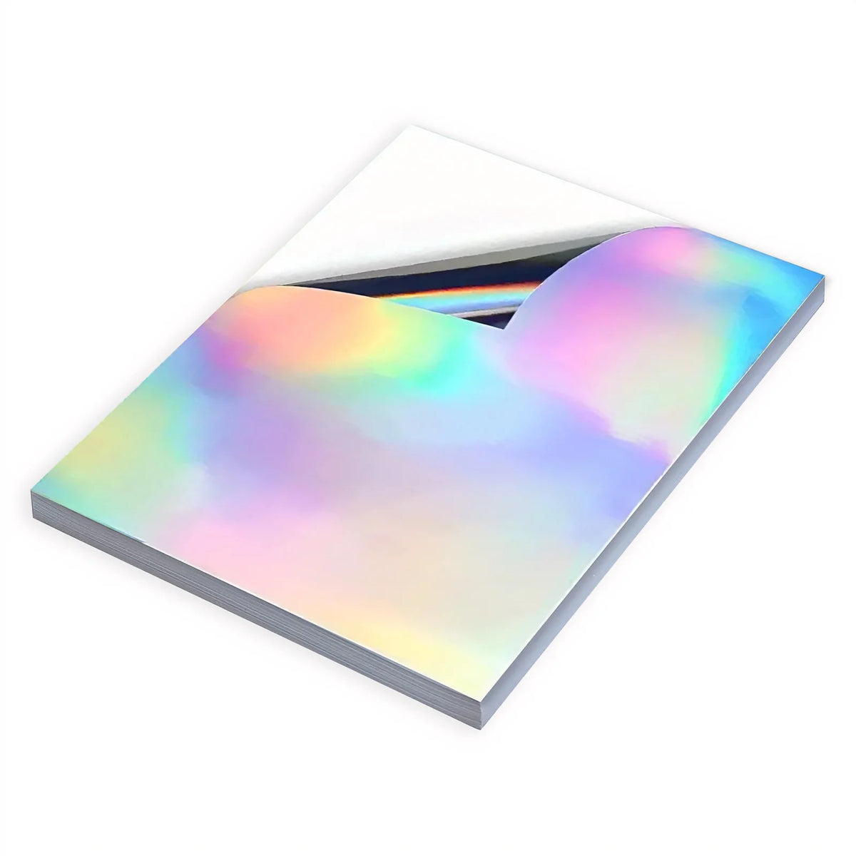 A stack of holographic rainbow sticker paper sheets is shown at an angle.