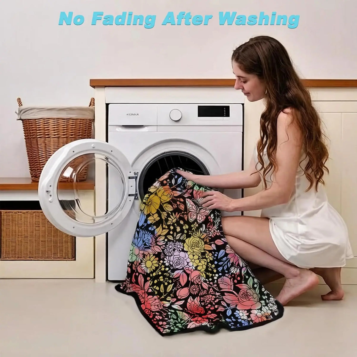 A woman is placing a floral patterned blanket into a white washing machine for cleaning.