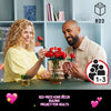 A woman and a man are assembling an 822-piece home decor building project featuring red roses.