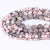 A loose strand of natural sea sediment jasper and turquoise beads for jewelry making