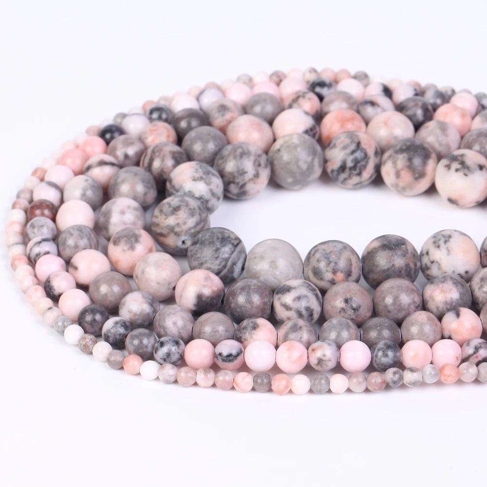 A loose strand of natural sea sediment jasper and turquoise beads for jewelry making