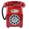 A vintage red rotary telephone shaped piggy bank with a circular dial and a speaker grille.