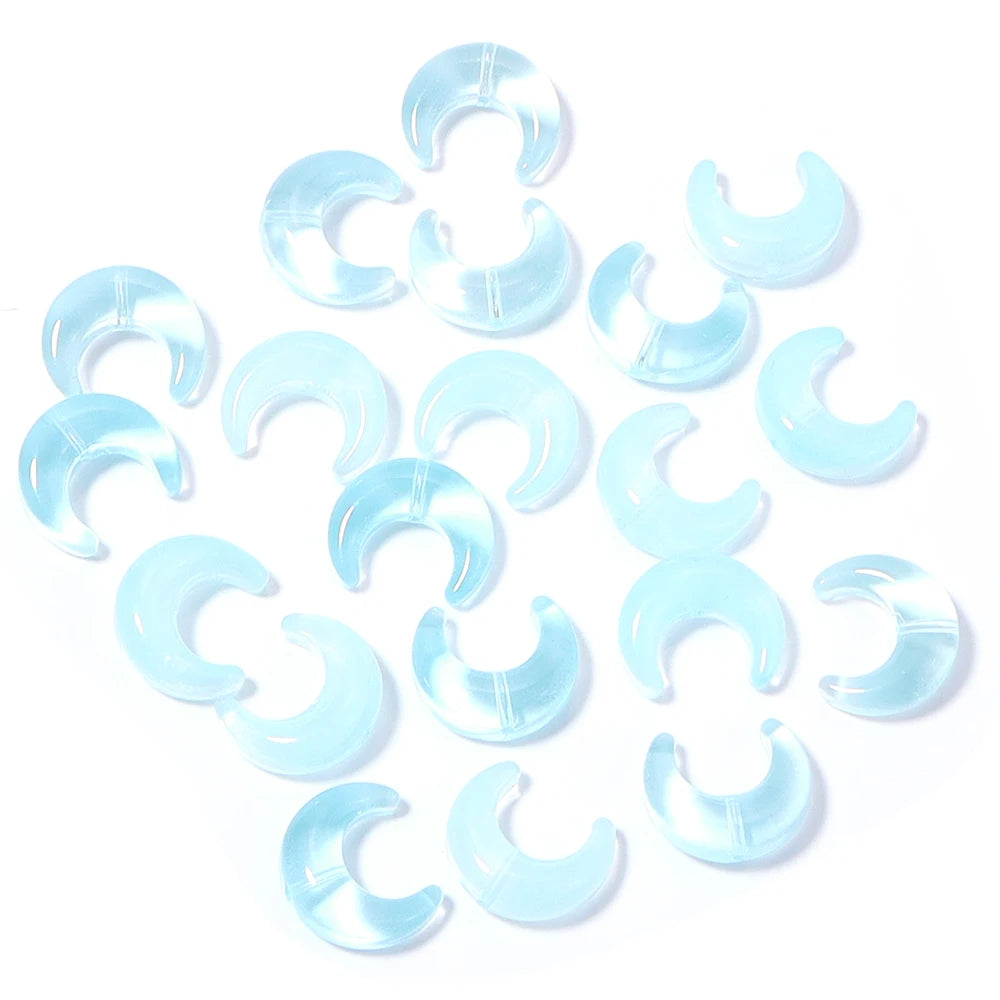 A collection of light blue moon-shaped glass beads for DIY jewelry making
