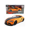 Diecast model of a bright orange Toyota GR Supra sports car in a box and as a finished collectible.