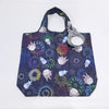 A dark blue fabric bag featuring a pattern of cute, stylized hippo and other animal faces in various colors.