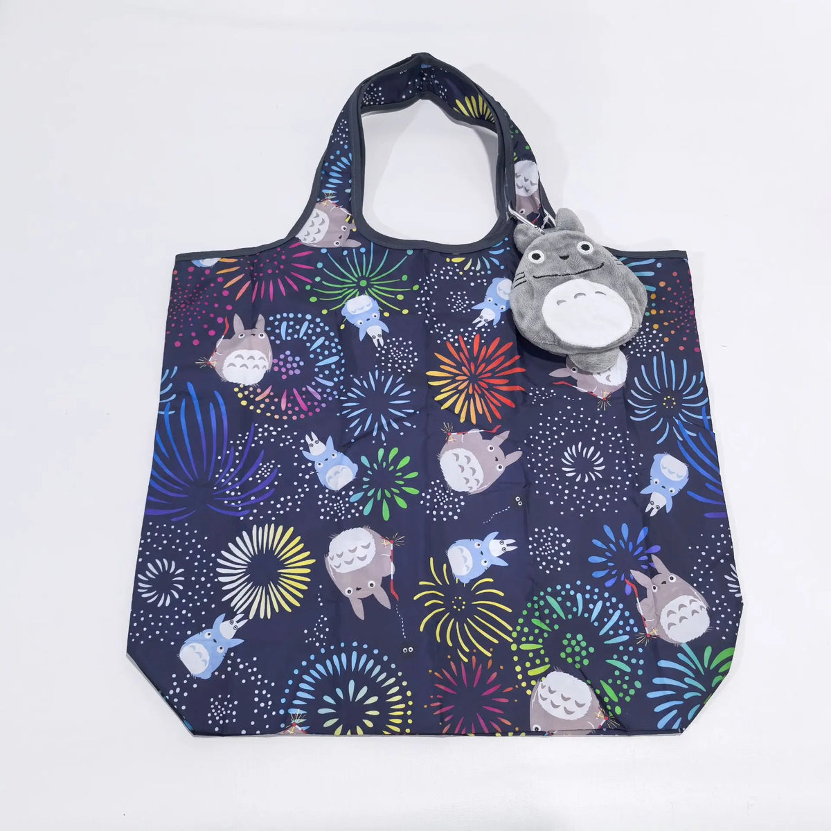 A dark blue fabric bag featuring a pattern of cute, stylized hippo and other animal faces in various colors.
