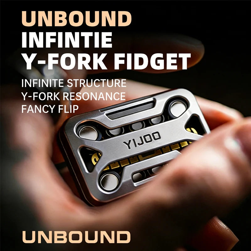 A hand holds an Unbound Infinity Y-Fork fidget gadget, a metal magnetic slider with a Y-fork structure.