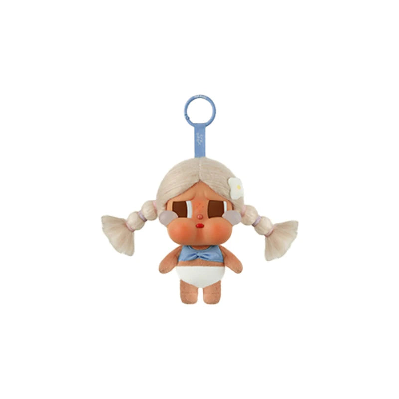 A vinyl figure of a character with blonde hair and blue accents, featuring a hook for display.