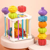 A set of colorful Montessori shape sorting cubes stacked in a tower with elastic bands.