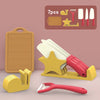A set of seven pretend play kitchen tools including pots, pans, utensils, and a cutting board displayed on a pink background.