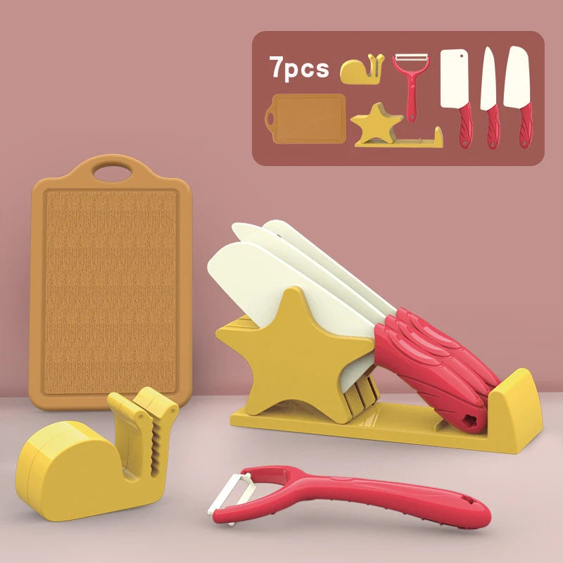 A set of seven pretend play kitchen tools including pots, pans, utensils, and a cutting board displayed on a pink background.