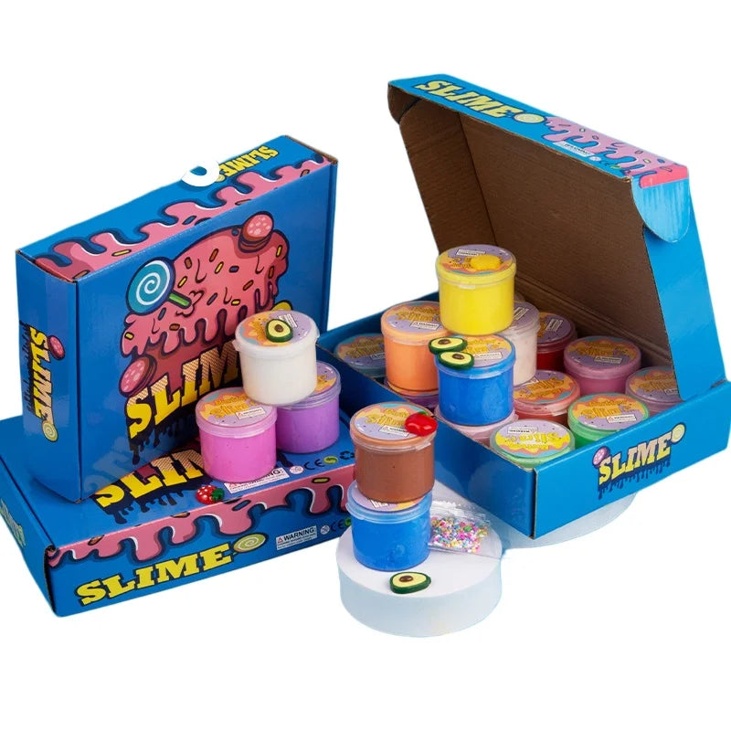 A box of slime with various colored slime containers and cake decorations displayed on a white surface.