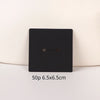 A black square jewelry display card with a small horizontal slot is shown against a light background.
