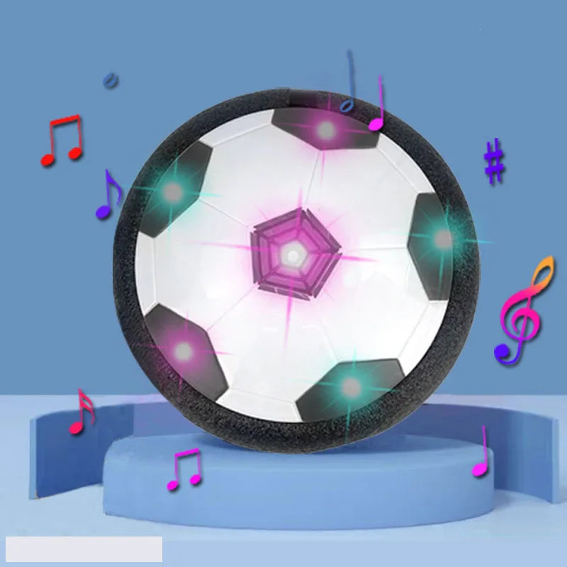 A glowing LED hover soccer ball is displayed on a blue stand with musical notes floating around it.