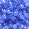 A close-up view of small, round, translucent blue glass beads for DIY jewelry making.
