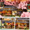 A detailed wooden miniature dollhouse theater kit featuring furniture and decorative elements.