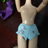 A doll fashion set featuring a light blue outfit with a white rabbit pattern.