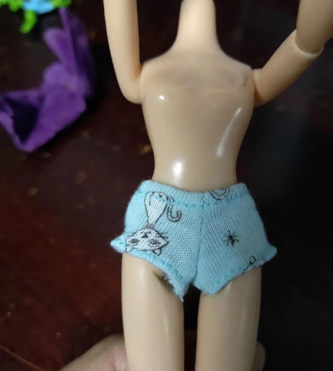 A doll fashion set featuring a light blue outfit with a white rabbit pattern.