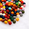 A pile of natural wooden beads in various colors and shapes for jewelry making and DIY crafts