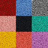A grid of various colored round glass seed beads for jewelry making including red blue silver black green and yellow