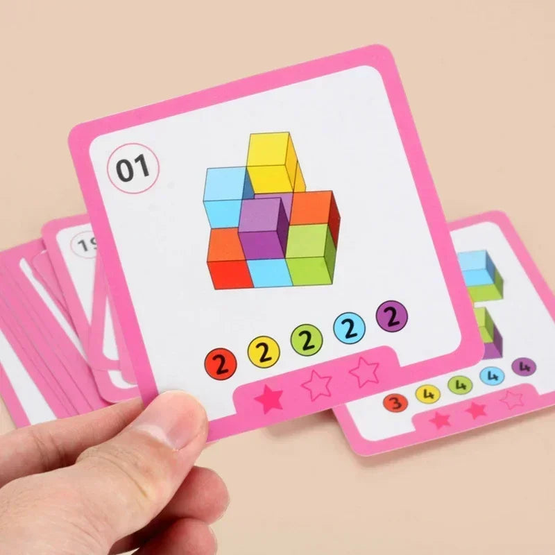 Eine Hand hält eine rosa Montessori Stapelspielkarton mit einem farbigen Würfel und nummerierten Punkten.