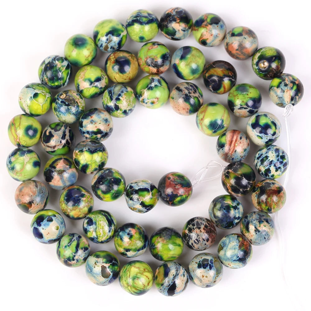A circular arrangement of natural sea sediment jasper and turquoise beads for jewelry making