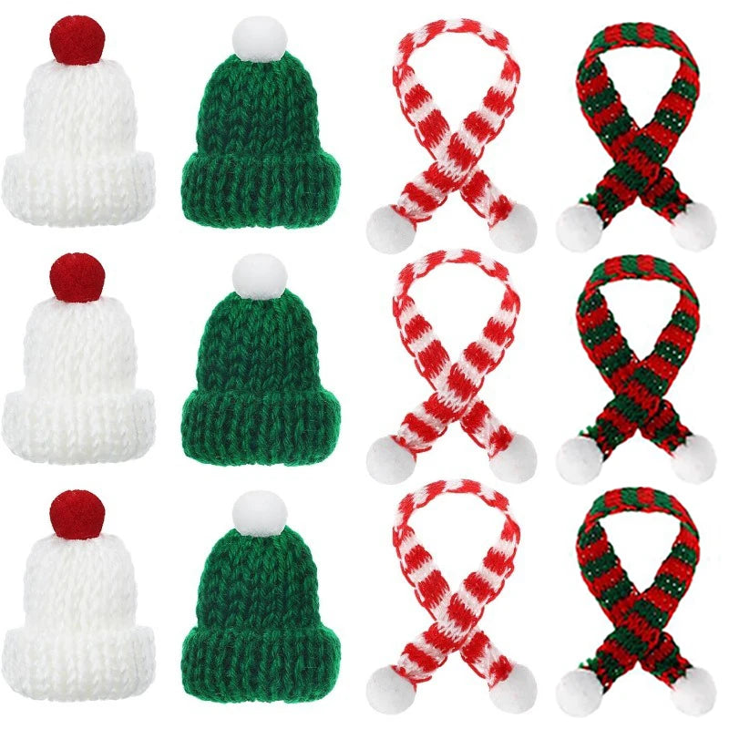 A set of mini knitted hat and scarf accessories for dolls featuring white and green yarn with red accents.