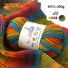 A close-up of three balls of gradient acrylic yarn in various colors, bundled together for knitting or crochet projects.